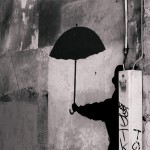man with dark umbrella by Camil Tulcan